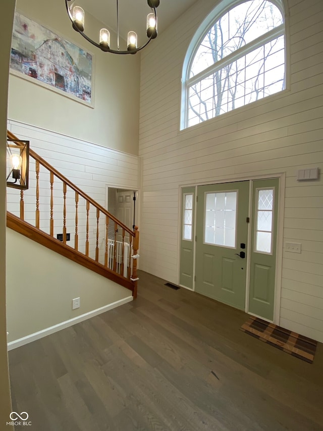 7195 W 700 N, Fairland, IN 46126 - foyer with wood finished floors, a chandelier, stairs, a towering ceiling, and wooden walls