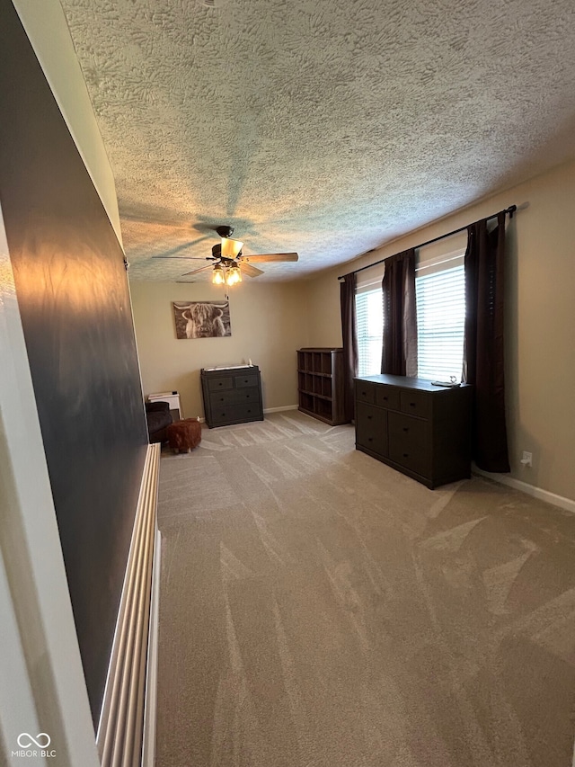 7195 W 700 N, Fairland, IN 46126 - unfurnished living room with a ceiling fan, light colored carpet, and a textured ceiling