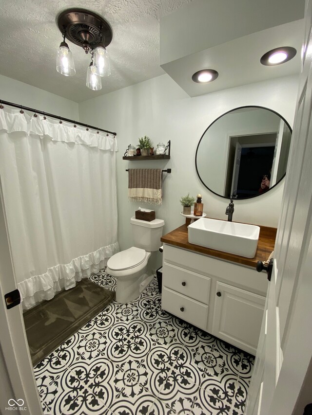 7195 W 700 N, Fairland, IN 46126 - bathroom featuring vanity, a textured ceiling, tile patterned flooring, and shower / bathtub combination with curtain