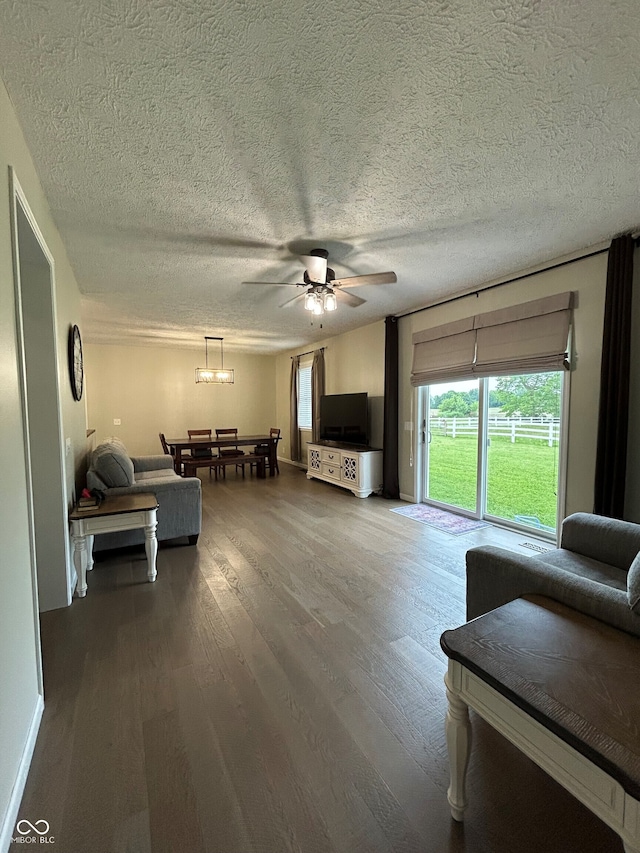 7195 W 700 N, Fairland, IN 46126 - living area featuring a ceiling fan, wood finished floors, healthy amount of natural light, a textured ceiling, and a chandelier