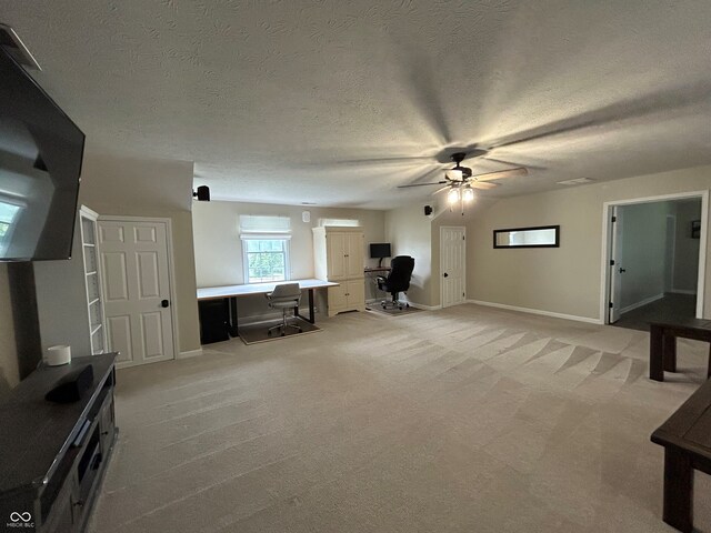 7195 W 700 N, Fairland, IN 46126 - living room with a desk, a ceiling fan, light colored carpet, and a textured ceiling