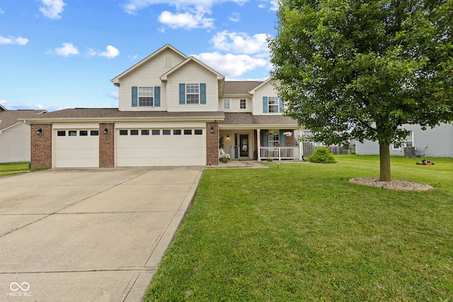 2580 Bluewood Way, Plainfield, IN 46168 - view of front of property featuring brick siding, driveway, covered porch, a front yard, and a garage