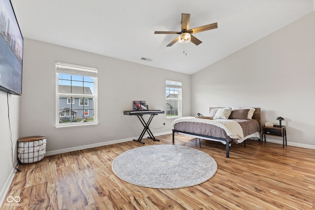 2580 Bluewood Way, Plainfield, IN 46168 - bedroom featuring multiple windows, wood finished floors, lofted ceiling, and a ceiling fan