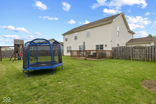 2580 Bluewood Way, Plainfield, IN 46168 - back of house featuring a trampoline, a deck, a fenced backyard, a playground, and a gate
