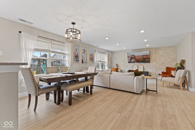 2580 Bluewood Way, Plainfield, IN 46168 - dining room with light wood-style floors, a chandelier, recessed lighting, and brick wall