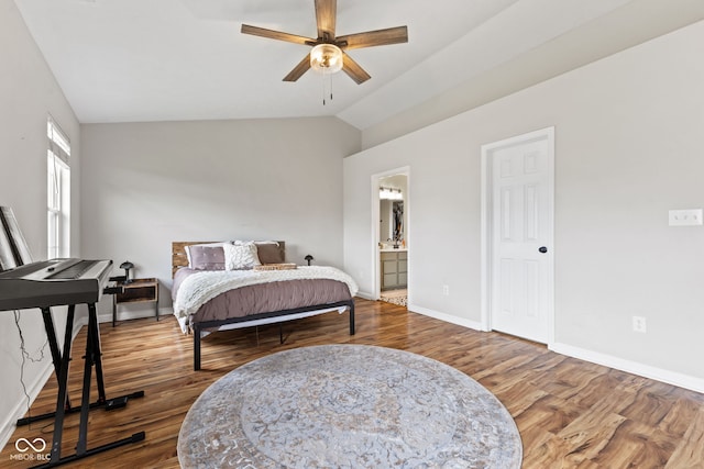 2580 Bluewood Way, Plainfield, IN 46168 - bedroom featuring wood finished floors, vaulted ceiling, ensuite bathroom, and a ceiling fan