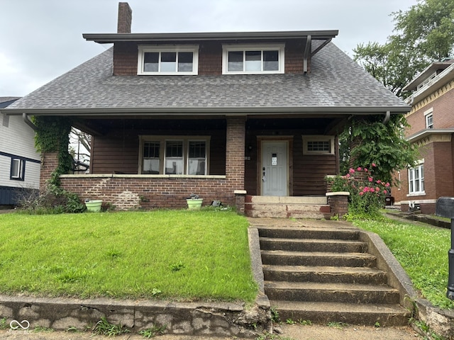 18 E Church St, Brazil, IN 47834 - view of front of home featuring roof with shingles, a porch, and a front yard