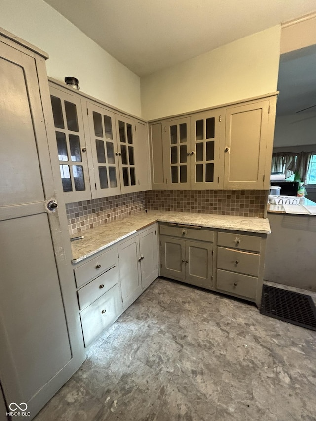 18 E Church St, Brazil, IN 47834 - kitchen featuring gray cabinets, tasteful backsplash, and glass insert cabinets