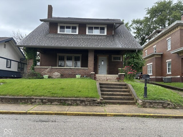 18 E Church St, Brazil, IN 47834 - view of front of home featuring a shingled roof, a chimney, covered porch, and a front lawn