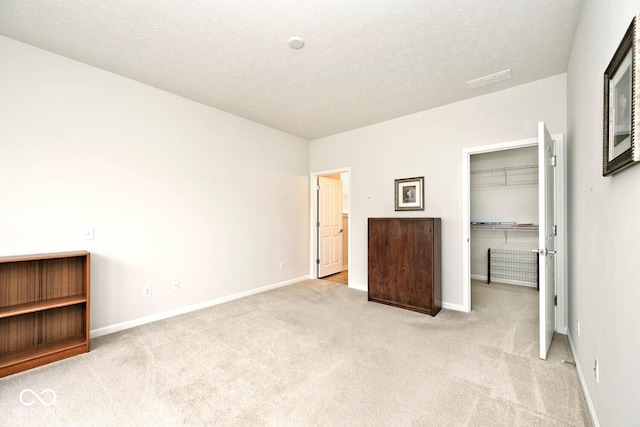 15937 Marsala Dr, Fishers, IN 46037 - unfurnished bedroom with carpet flooring, baseboards, a spacious closet, a textured ceiling, and a closet