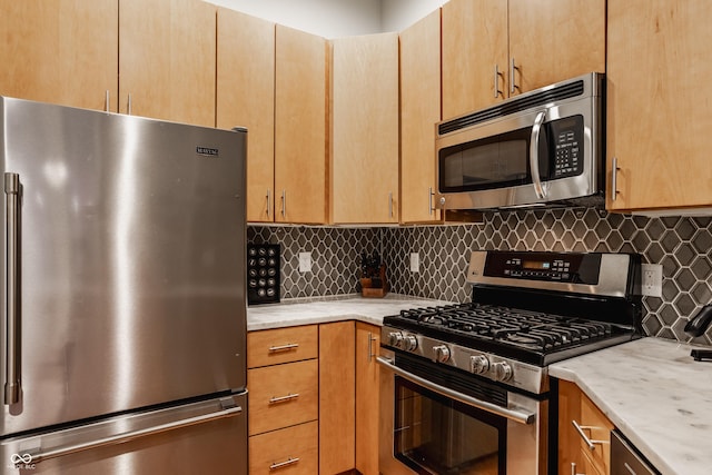 611 N Park Ave Unit 104, Indianapolis, IN 46204 - kitchen featuring appliances with stainless steel finishes, backsplash, and light brown cabinets