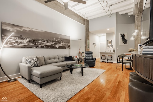 611 N Park Ave Unit 104, Indianapolis, IN 46204 - living area with a high ceiling, light wood-style flooring, ceiling fan, and baseboards