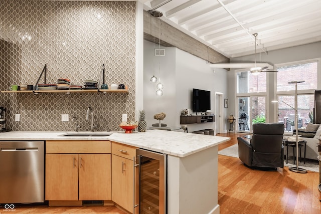 611 N Park Ave Unit 104, Indianapolis, IN 46204 - kitchen with stainless steel dishwasher, beverage cooler, open shelves, a sink, and a towering ceiling