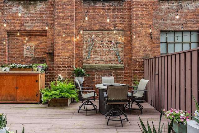 611 N Park Ave Unit 104, Indianapolis, IN 46204 - wooden terrace with outdoor dining area