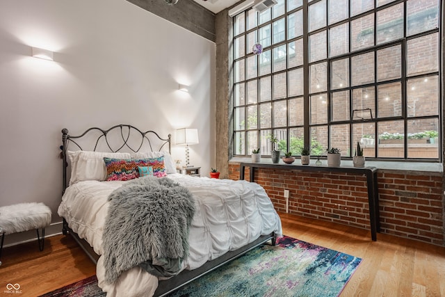 611 N Park Ave Unit 104, Indianapolis, IN 46204 - bedroom with wood finished floors, multiple windows, and a high ceiling