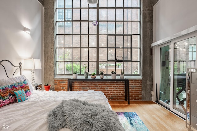 611 N Park Ave Unit 104, Indianapolis, IN 46204 - bedroom featuring wood finished floors and a high ceiling