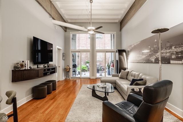 611 N Park Ave Unit 104, Indianapolis, IN 46204 - living area featuring ceiling fan, high vaulted ceiling, light wood-style floors, baseboards, and wooden ceiling with exposed beams
