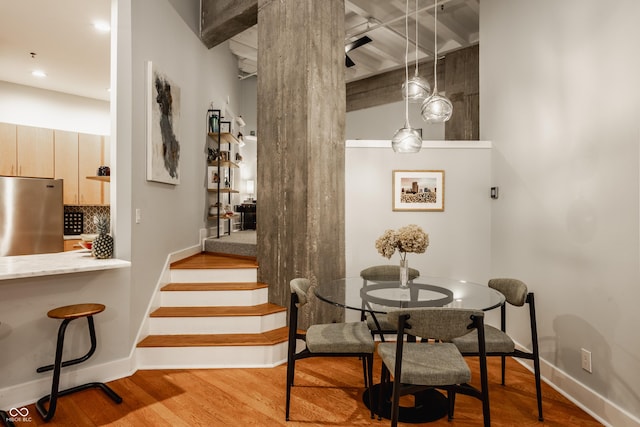 611 N Park Ave Unit 104, Indianapolis, IN 46204 - dining area with wood finished floors, baseboards, stairs, and recessed lighting