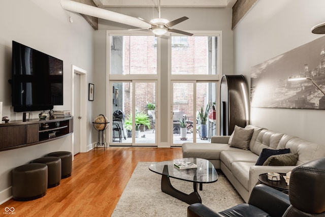 611 N Park Ave Unit 104, Indianapolis, IN 46204 - living area featuring a high ceiling, healthy amount of natural light, light wood finished floors, and a ceiling fan