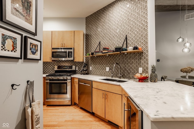 611 N Park Ave Unit 104, Indianapolis, IN 46204 - kitchen with stainless steel appliances, a sink, wine cooler, open shelves, and light wood-style floors