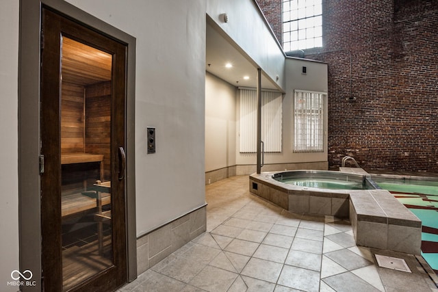 611 N Park Ave Unit 104, Indianapolis, IN 46204 - bathroom featuring a high ceiling, a sauna, a garden tub, and tile patterned flooring