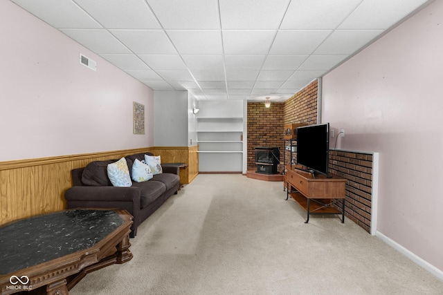 1350 Inverness Farms Rd, Martinsville, IN 46151 - living area with carpet flooring, wainscoting, a drop ceiling, a wood stove, and wood walls