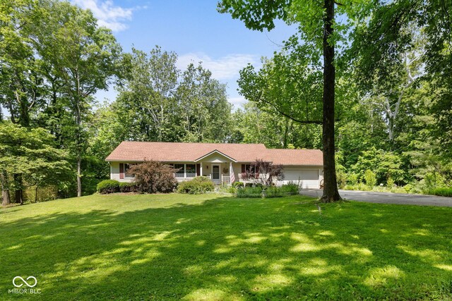 1350 Inverness Farms Rd, Martinsville, IN 46151 - view of front of house featuring asphalt driveway, a garage, a front lawn, and covered porch