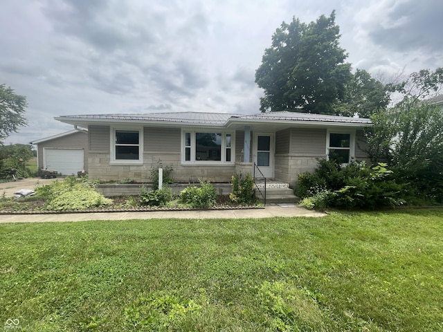 4363 Roosevelt Dr, Columbus, IN 47201 - ranch-style house featuring a garage, a front lawn, stone siding, and metal roof