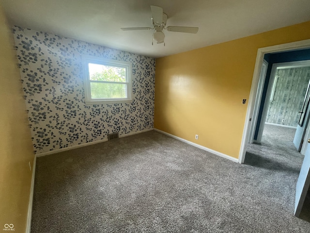 4363 Roosevelt Dr, Columbus, IN 47201 - spare room with carpet, a ceiling fan, wallpapered walls, and baseboards
