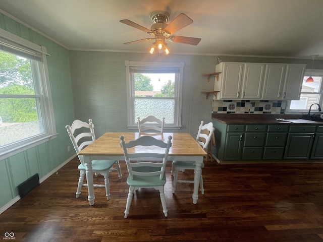 4363 Roosevelt Dr, Columbus, IN 47201 - dining space featuring crown molding, dark wood-style floors, a ceiling fan, and baseboards