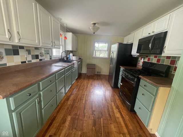 4363 Roosevelt Dr, Columbus, IN 47201 - kitchen featuring black appliances, dark wood-style floors, white cabinetry, tasteful backsplash, and dark countertops