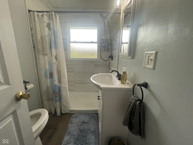 4363 Roosevelt Dr, Columbus, IN 47201 - full bathroom featuring toilet, vanity, tiled shower, and wood finished floors