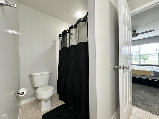 4925 Chip Shot Ln, Indianapolis, IN 46235 - full bath featuring a textured ceiling, toilet, ensuite bath, curtained shower, and tile patterned flooring