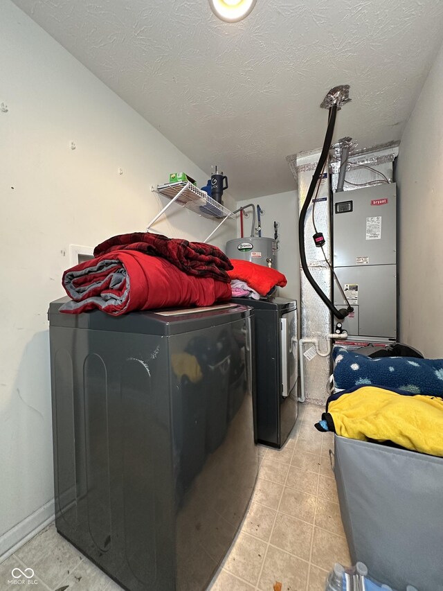 4925 Chip Shot Ln, Indianapolis, IN 46235 - laundry room featuring washer and clothes dryer, light tile patterned floors, a textured ceiling, and heating unit
