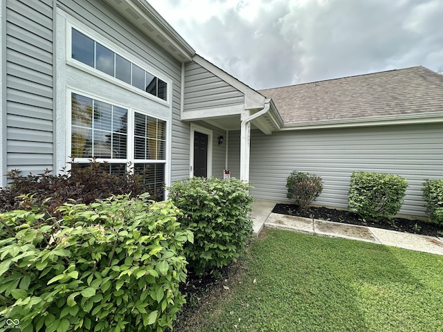 4925 Chip Shot Ln, Indianapolis, IN 46235 - property entrance featuring a shingled roof and a yard