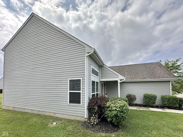 4925 Chip Shot Ln, Indianapolis, IN 46235 - view of home's exterior with a lawn and roof with shingles
