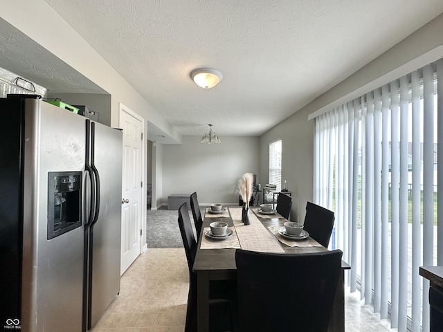 4925 Chip Shot Ln, Indianapolis, IN 46235 - dining space featuring a chandelier and a textured ceiling