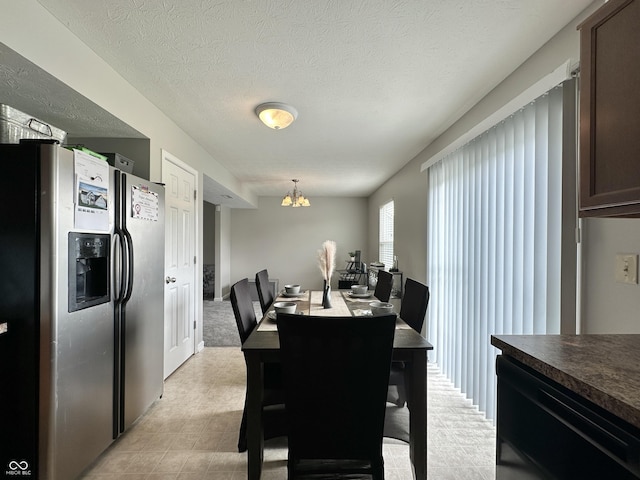 4925 Chip Shot Ln, Indianapolis, IN 46235 - dining room featuring a chandelier and a textured ceiling