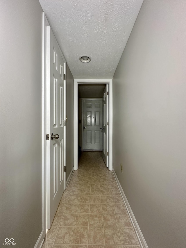 4925 Chip Shot Ln, Indianapolis, IN 46235 - hallway featuring baseboards and a textured ceiling