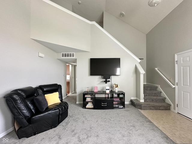 4925 Chip Shot Ln, Indianapolis, IN 46235 - carpeted living area featuring high vaulted ceiling, stairway, and baseboards