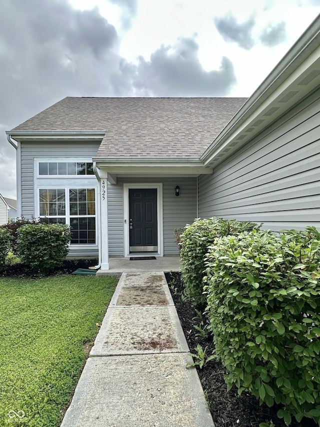 4925 Chip Shot Ln, Indianapolis, IN 46235 - doorway to property with a lawn and a shingled roof
