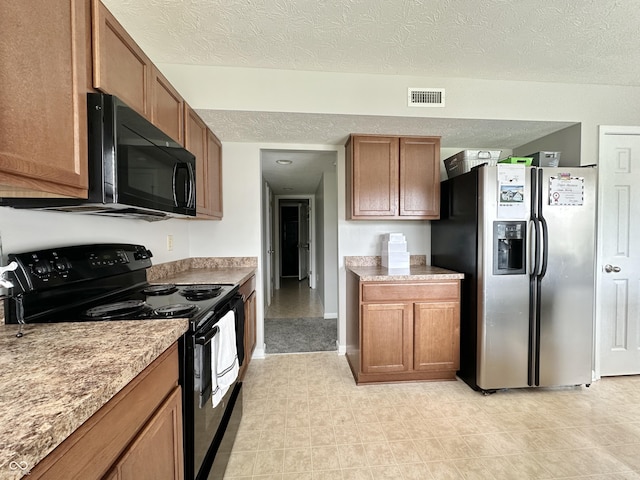4925 Chip Shot Ln, Indianapolis, IN 46235 - kitchen with black appliances, brown cabinetry, a textured ceiling, and light countertops