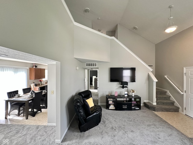 4925 Chip Shot Ln, Indianapolis, IN 46235 - living room with light carpet, high vaulted ceiling, stairway, and baseboards