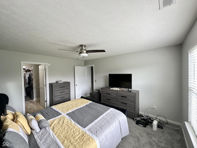 4925 Chip Shot Ln, Indianapolis, IN 46235 - bedroom with ceiling fan, carpet flooring, baseboards, a spacious closet, and a textured ceiling