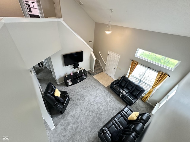 4925 Chip Shot Ln, Indianapolis, IN 46235 - carpeted living room featuring high vaulted ceiling and stairway