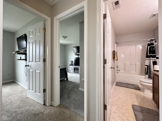 4925 Chip Shot Ln, Indianapolis, IN 46235 - corridor featuring a textured ceiling, light colored carpet, and baseboards