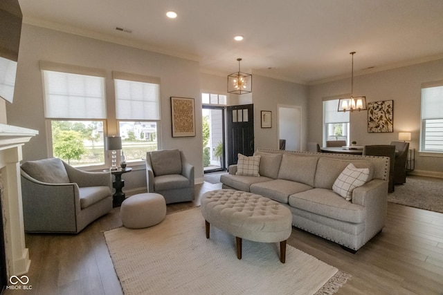 139 Wayfinder Dr, West Lafayette, IN 47906 - living area featuring a chandelier, ornamental molding, recessed lighting, wood finished floors, and baseboards