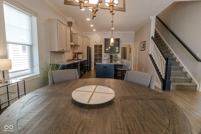 139 Wayfinder Dr, West Lafayette, IN 47906 - dining room featuring stairs, a chandelier, light wood-style flooring, crown molding, and recessed lighting