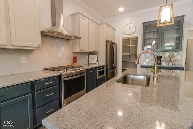 139 Wayfinder Dr, West Lafayette, IN 47906 - kitchen with stainless steel appliances, wall chimney exhaust hood, a sink, backsplash, and hanging light fixtures