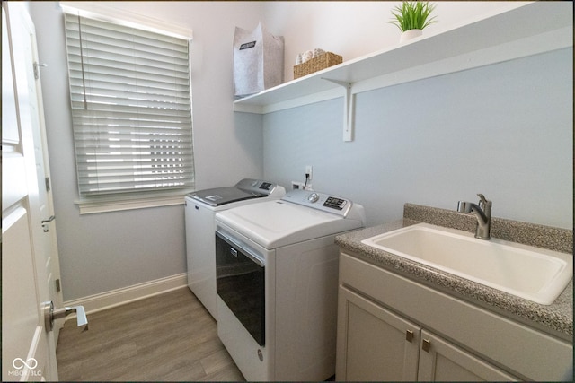 139 Wayfinder Dr, West Lafayette, IN 47906 - laundry area featuring washer and dryer, light wood-style flooring, baseboards, and cabinet space